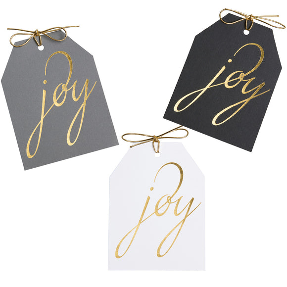 Joy gold foil gift tags on gray, black, and white linen paper with metallic gold ties. 4x5.5