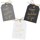 Gold foil Happy Holidays To You gift tags on gray, black, and white linen paper, with metallic gold ties. 3x4