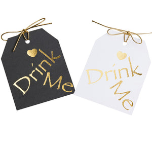 Gold foil on black or white paper.Drimk Me gift tags with a gold heart above the word Drimk Me. 3.5x4" wirh  gold metallic tie