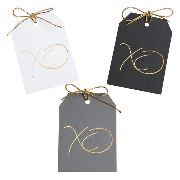 Gold foil XO gift tags on white, black,and gray paper with metallic gold ties. 3x4